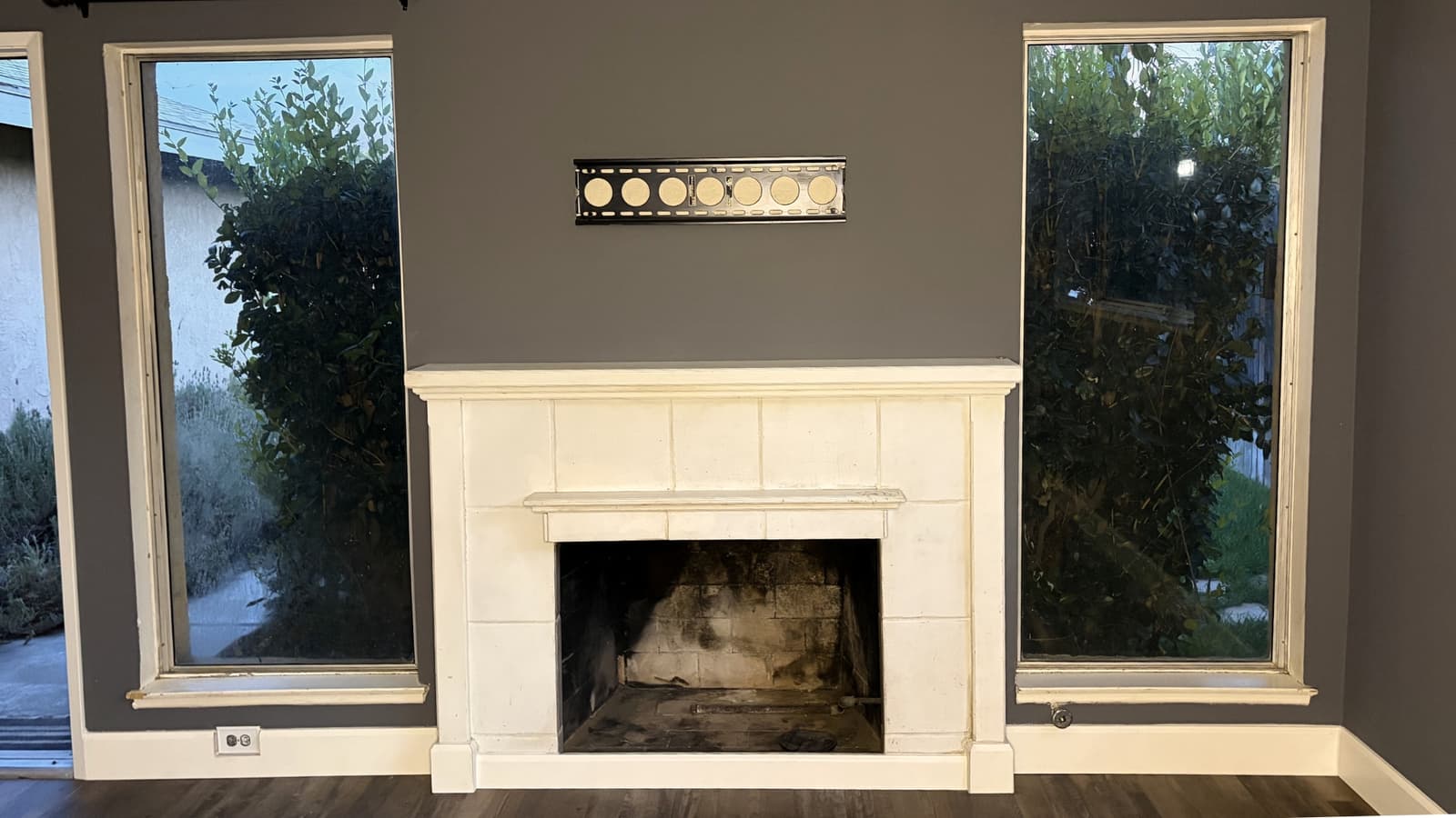 Interior finish featuring painted fireplace, new flooring, and clean wall finishes in a living room