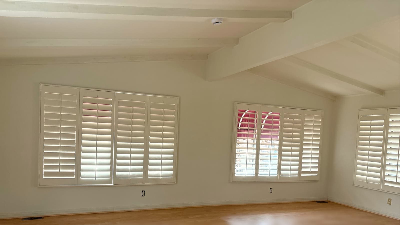 Interior space with fresh paint, clean walls, and finished flooring with natural light