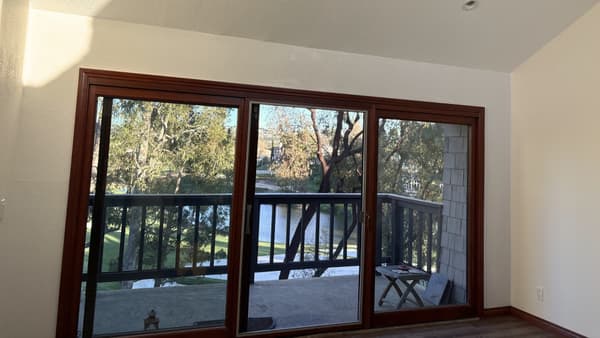 Interior finish with large sliding glass doors, wood trim, and bright natural lighting