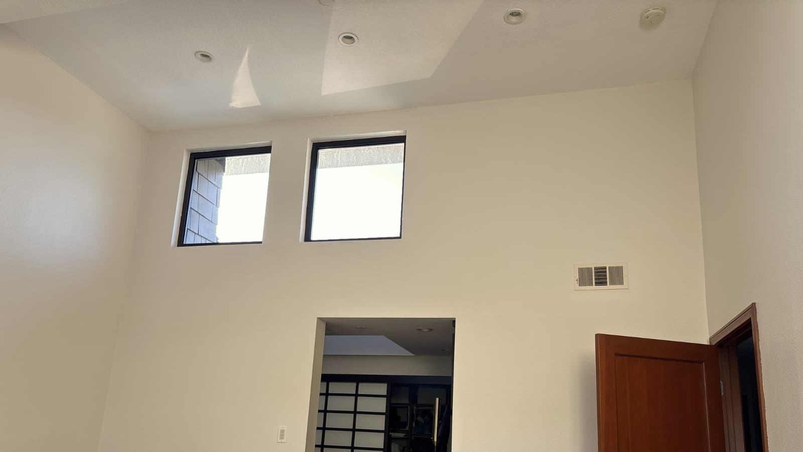 High ceiling interior with drywall finish, recessed lighting, and clean paint work