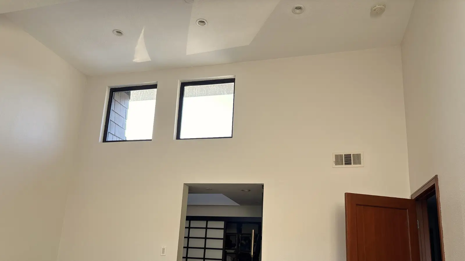 Completed high ceiling and wall finishes in a custom Newport Beach home